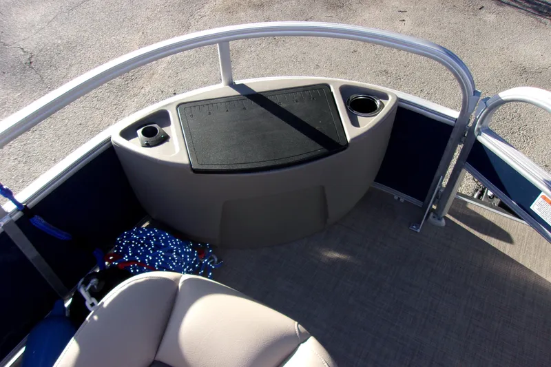 Slide: The Image of 2023 Sun Tracker Bass Buggy 18 DLX pontoon boat interior with cup holders and seating. - 15
