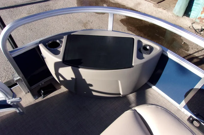 Slide: The Image of 2023 Sun Tracker Bass Buggy 18 DLX pontoon boat interior with cup holders and seating. - 16