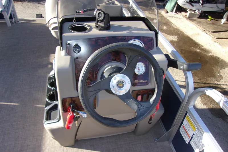 Slide: The Image of 2023 Sun Tracker Bass Buggy 18 DLX steering console with gauges and controls. - 6