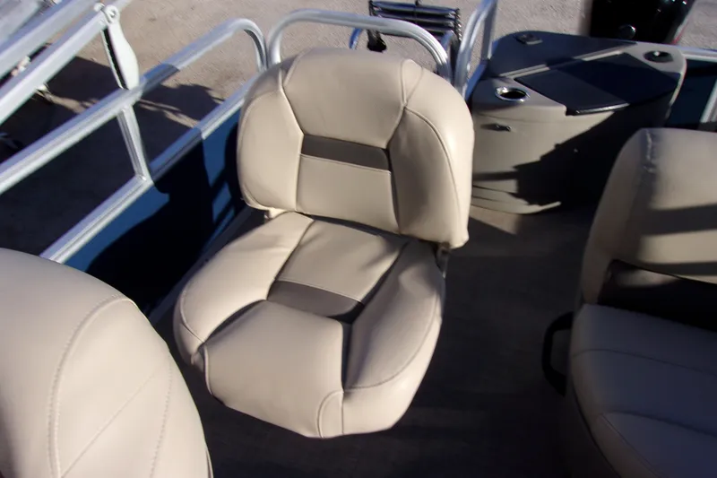 Slide: The Image of 2023 Sun Tracker Bass Buggy 18 DLX boat seat, beige upholstery, and metal railing. - 9