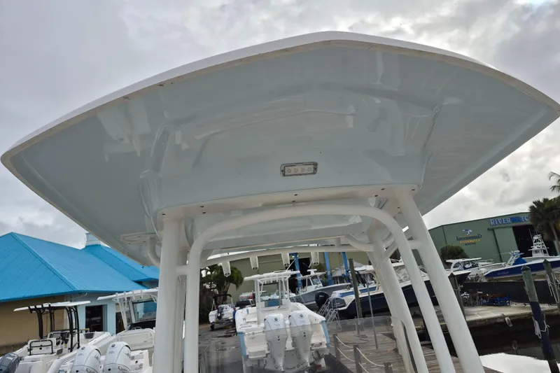 Slide: The Image of 2017 Robalo R222 Center Console boat with T-top, docked at marina. - 13