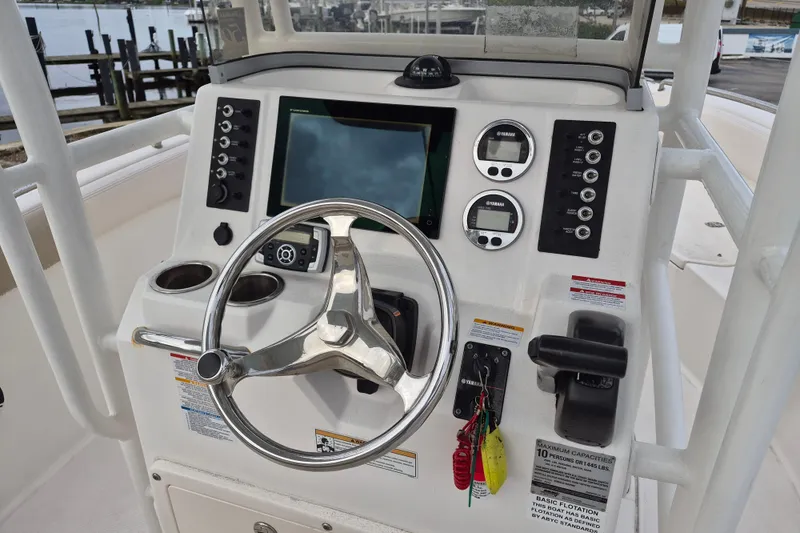 Slide: The Image of 2017 Robalo R222 Center Console boat dashboard with steering wheel and control panel. - 6