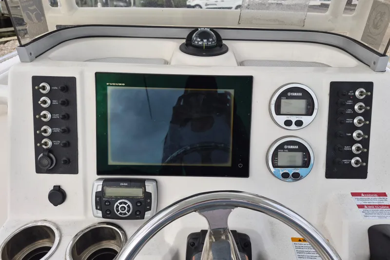 Slide: The Image of 2017 Robalo R222 Center Console dashboard with navigation and control instruments. - 8