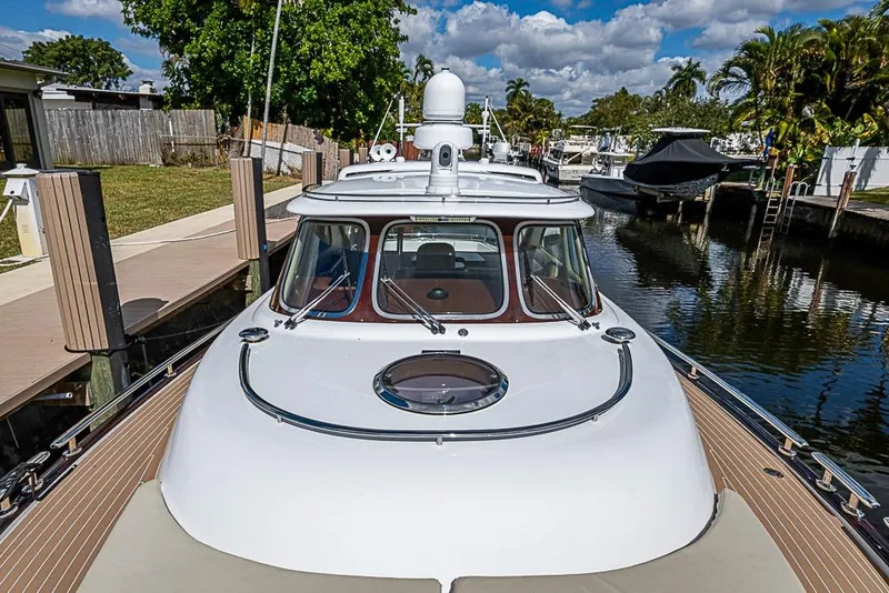 Slide: The Image of 2014 Zeelander Z44 yacht docked in a serene marina setting. - 11