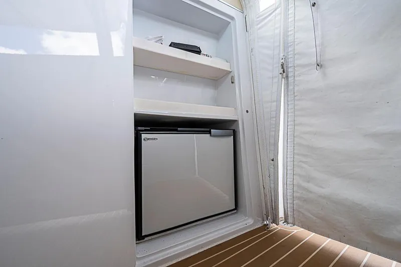Slide: The Image of Compact fridge inside 2014 Zeelander Z44 yacht, with shelves and white interior. - 18