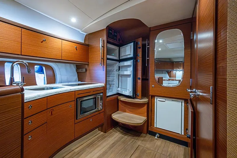 Slide: The Image of Luxurious 2014 Zeelander Z44 yacht interior with modern kitchen and wooden cabinetry. - 21
