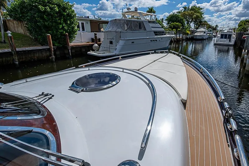 Slide: The Image of 2014 Zeelander Z44 yacht docked in a serene marina under a blue sky. - 31