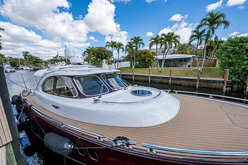 Slide: The Image of 2014 Zeelander Z44 yacht docked by a canal with palm trees and blue sky. - 36