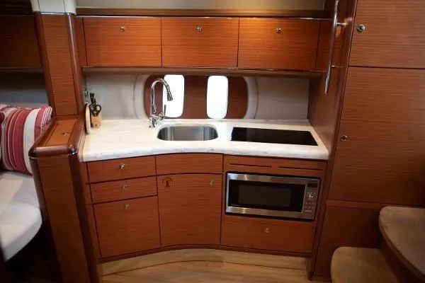 Slide: The Image of 2014 Zeelander Z44 yacht deck with elegant wood finish in marina setting. - 5