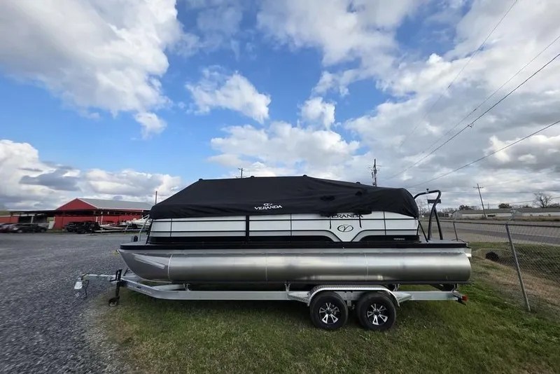 Slide: The Image of 2026 Veranda Vista Sport 22RC Tri-Toon boat on trailer under cloudy sky. - 3