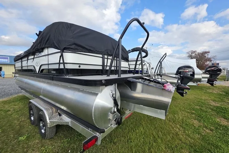 Slide: The Image of 2026 Veranda Vista Sport 22RC Tri-Toon boat on trailer, covered and parked outdoors. - 7