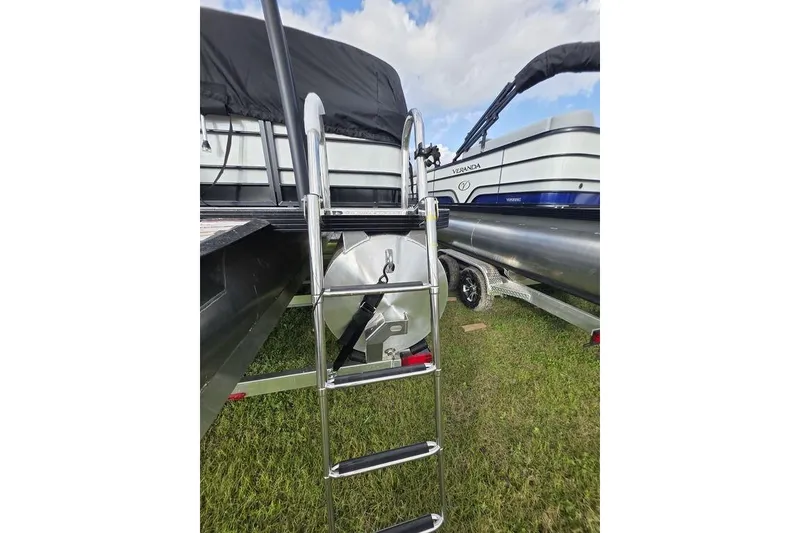 Slide: The Image of 2026 Veranda Vista Sport 22RC Tri-Toon with ladder on grassy field. - 8