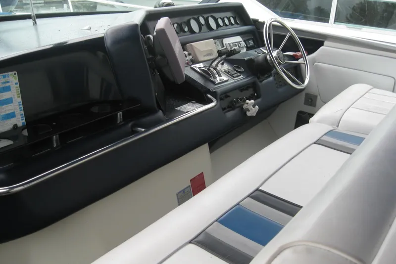 Slide: The Image of 1990 Sea Ray Sundancer 350 helm with steering wheel and control panel. - 11