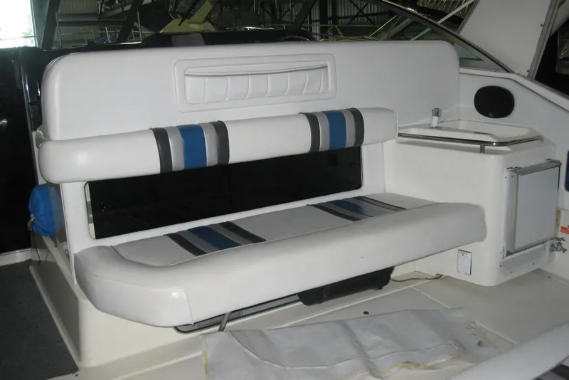 Slide: The Image of 1990 Sea Ray Sundancer 350 interior with white seating and compact sink area. - 12
