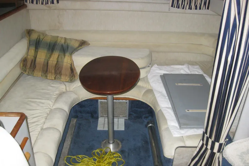 Slide: The Image of Interior of 1990 Sea Ray Sundancer 350 with cozy seating and nautical decor. - 20