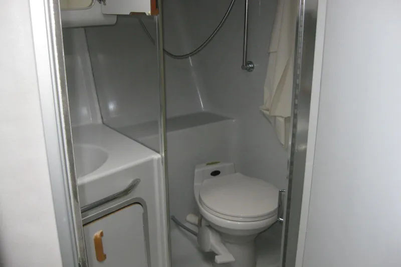 Slide: The Image of 1990 Sea Ray Sundancer 350 kitchen with sink, stove, microwave, and mini fridge. - 22