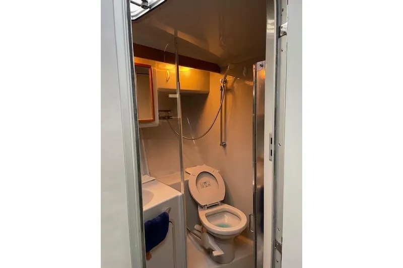 Slide: The Image of Bathroom interior of 1990 Sea Ray Sundancer 350 yacht, featuring toilet and sink. - 23