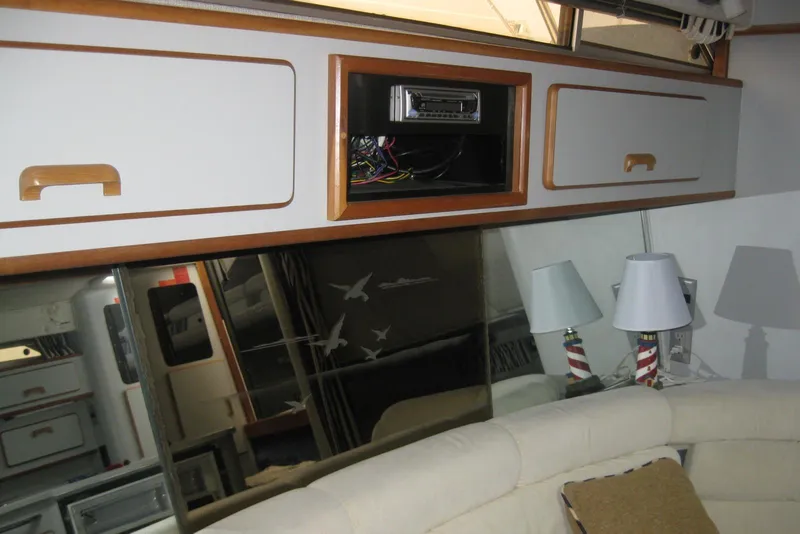 Slide: The Image of 1990 Sea Ray Sundancer 350 bathroom sink with storage cabinet and chrome faucet. - 25