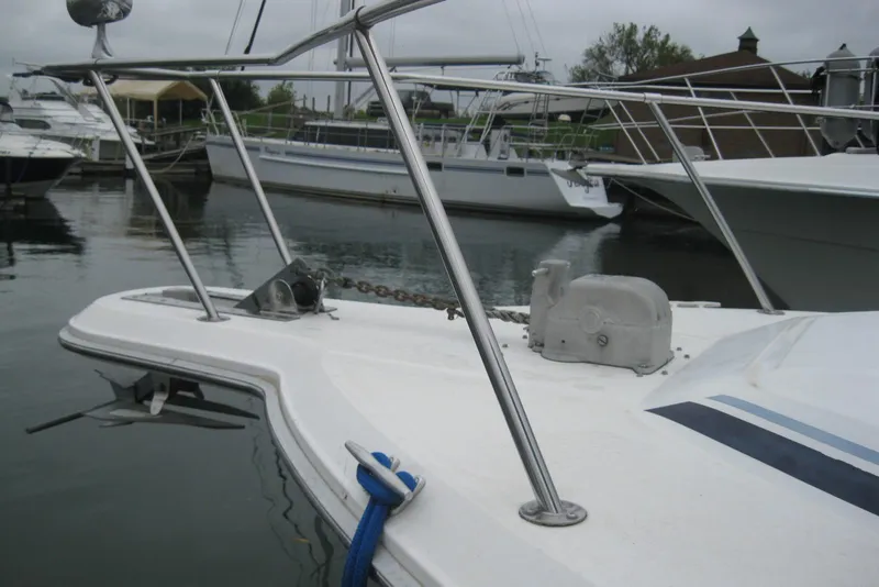 Slide: The Image of 1990 Sea Ray Sundancer 350 boat bow with anchor and railing in marina. - 3