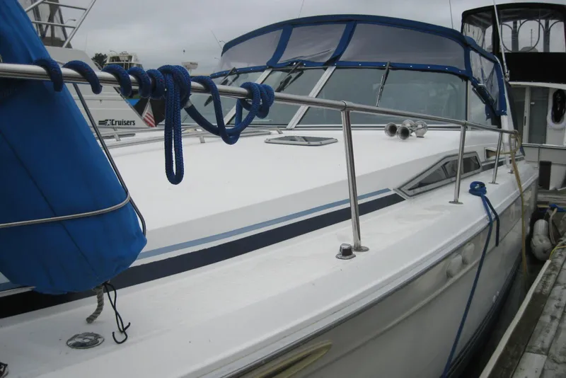 Slide: The Image of 1990 Sea Ray Sundancer 350 docked, featuring blue accents and protective railings. - 4