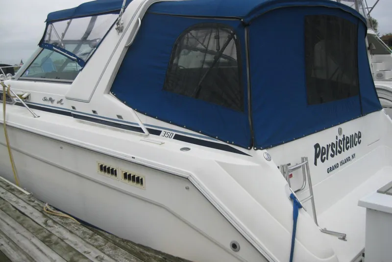 Slide: The Image of 1990 Sea Ray Sundancer 350 boat with blue canopy, docked at Grand Island, NY. - 5