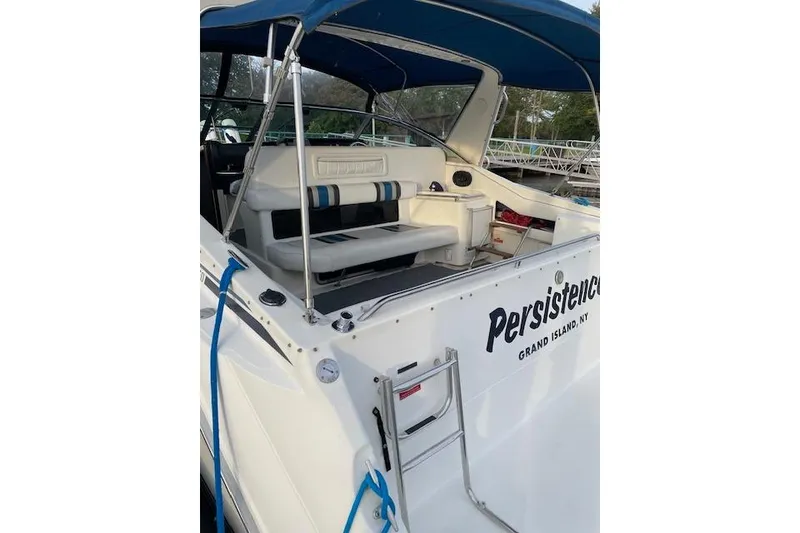 Slide: The Image of 1990 Sea Ray Sundancer 350 boat with blue canopy and seating, docked at Grand Island, NY. - 9