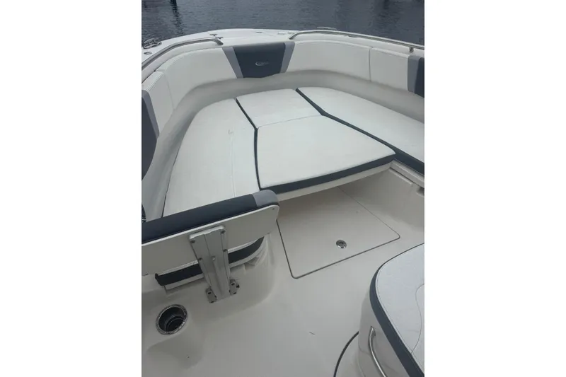 Slide: The Image of 2022 Robalo R272 Center Console boat interior with cushioned seating. - 10