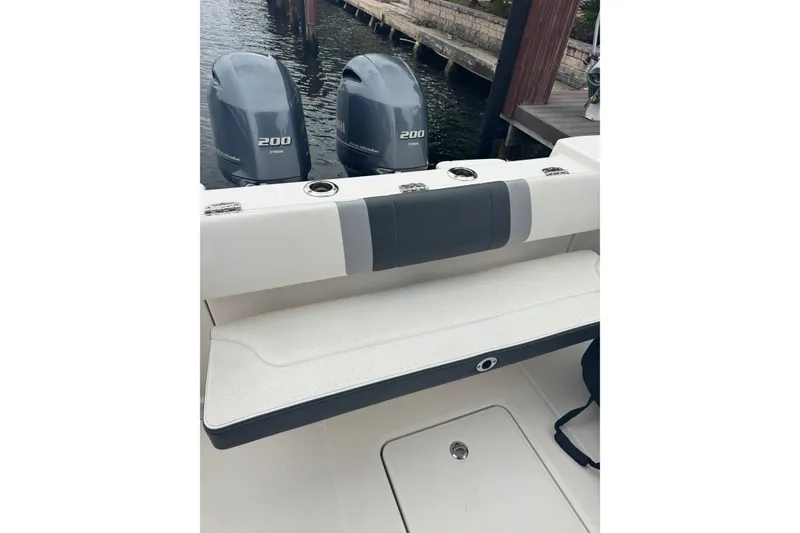 Slide: The Image of 2022 Robalo R272 Center Console with twin Yamaha 200 engines at dock. - 13