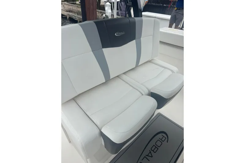 Slide: The Image of 2022 Robalo R272 Center Console boat seating, featuring sleek white and gray upholstery. - 15