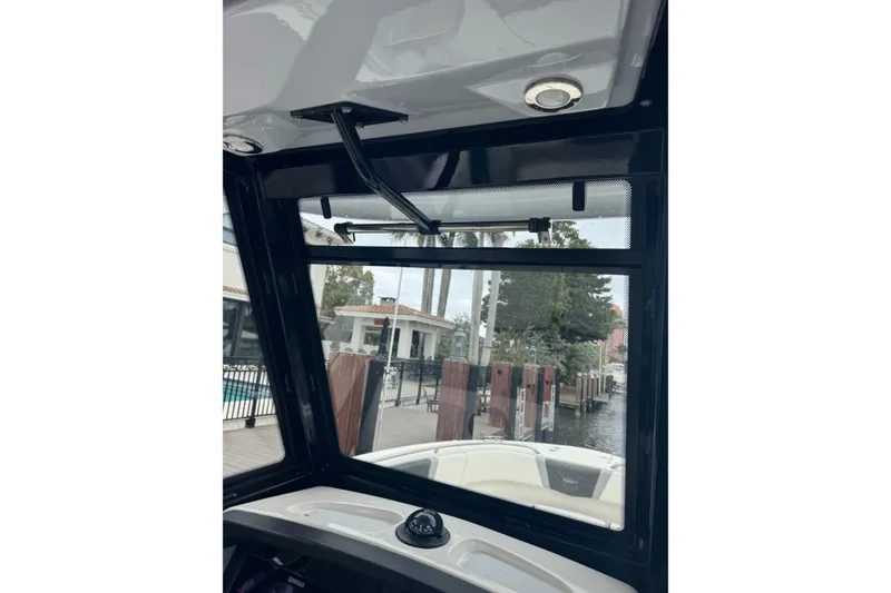 Slide: The Image of Interior view of 2022 Robalo R272 Center Console boat, showcasing window and console details. - 2