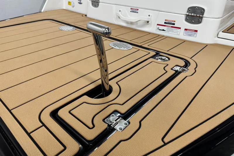 Slide: The Image of 2026 Chaparral SSX 4 boat deck with tan non-slip surface and chrome handle. - 13