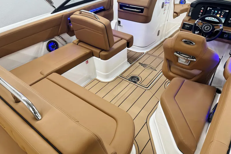 Slide: The Image of 2026 Chaparral SSX 4 boat interior with tan leather seats and modern dashboard. - 18