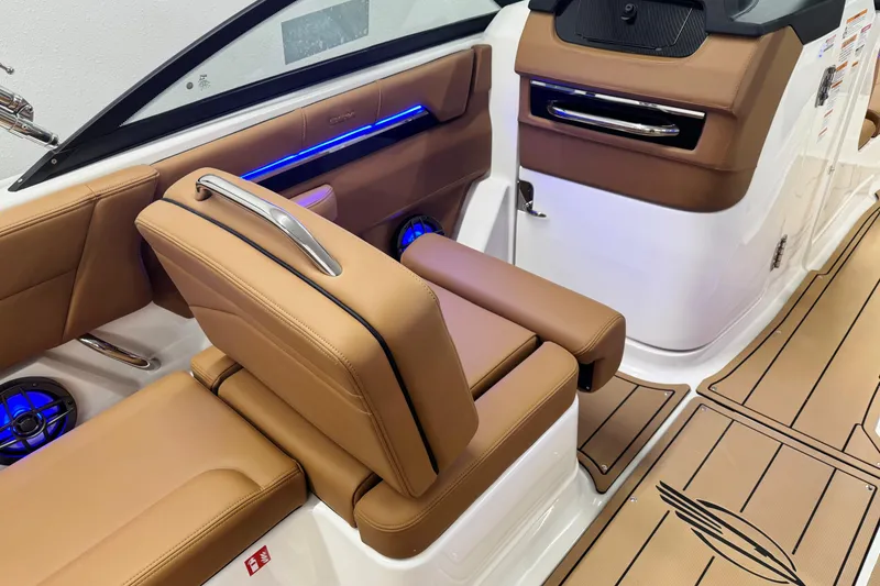 Slide: The Image of 2026 Chaparral SSX 4 boat interior with tan leather seats and blue LED lighting. - 19