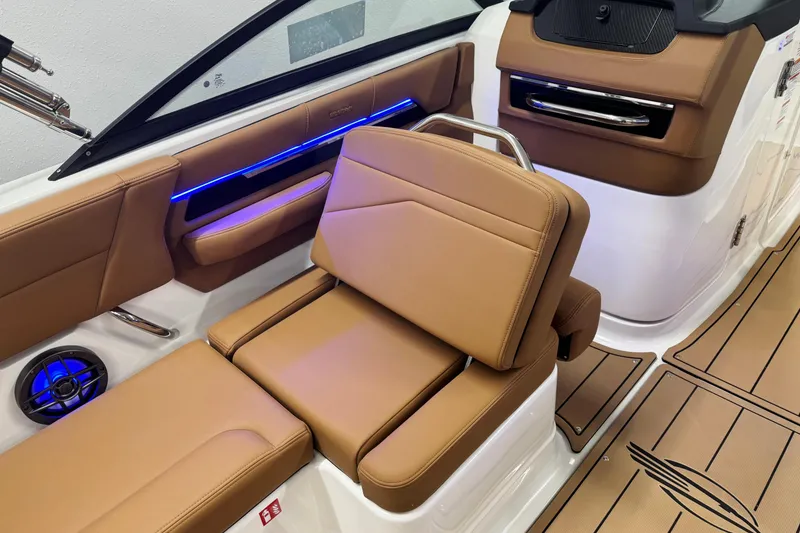 Slide: The Image of 2026 Chaparral SSX 4 boat interior with tan leather seating and blue LED lighting. - 20