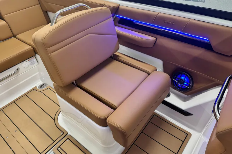 Slide: The Image of 2026 Chaparral SSX 4 boat interior with tan leather seating and blue LED lighting. - 22