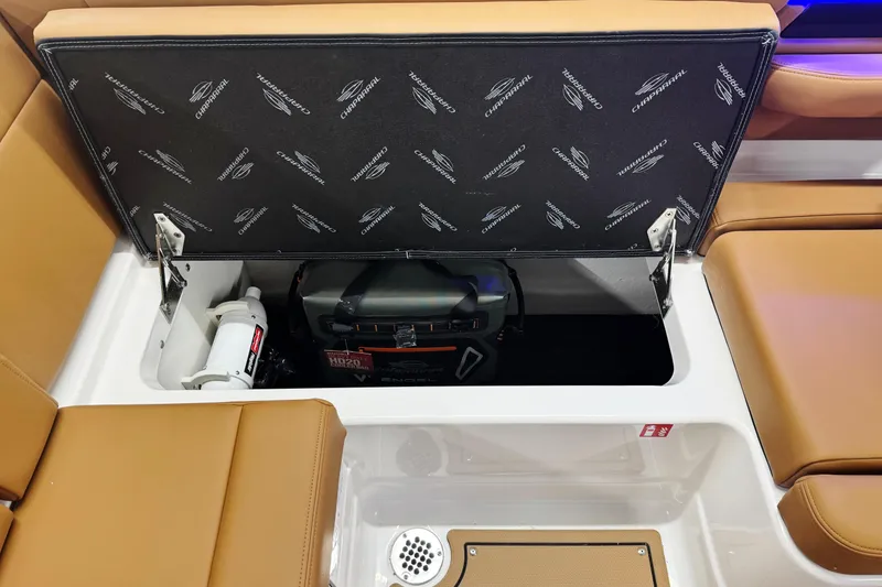 Slide: The Image of 2026 Chaparral SSX 4 boat storage compartment with safety equipment and accessories. - 26