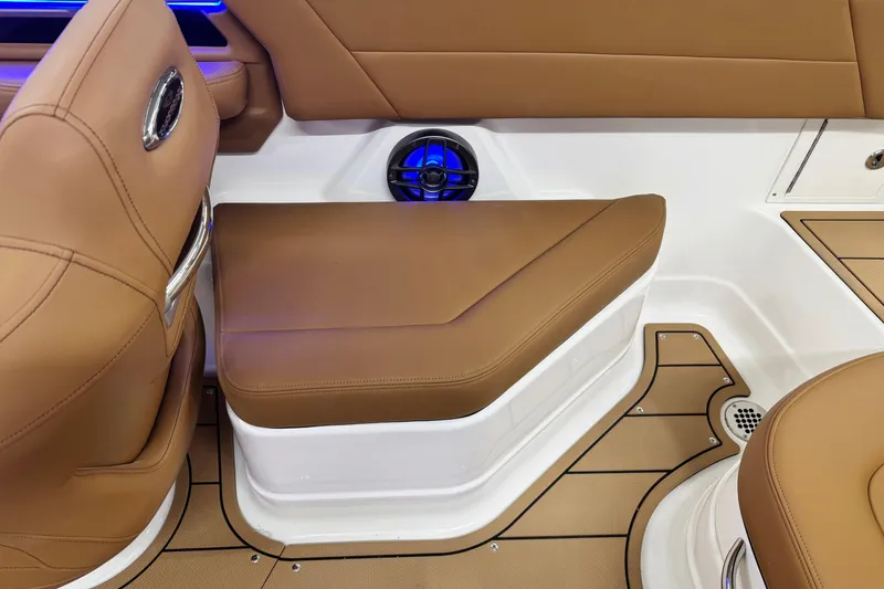 Slide: The Image of 2026 Chaparral SSX 4 boat interior with tan seating and blue LED lighting. - 27