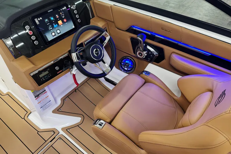 Slide: The Image of 2026 Chaparral SSX 4 boat interior with modern dashboard and luxurious tan seating. - 29
