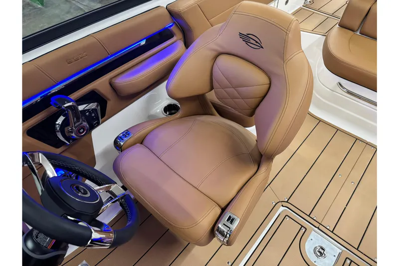 Slide: The Image of 2026 Chaparral SSX 4 boat interior with tan leather seating and modern controls. - 31