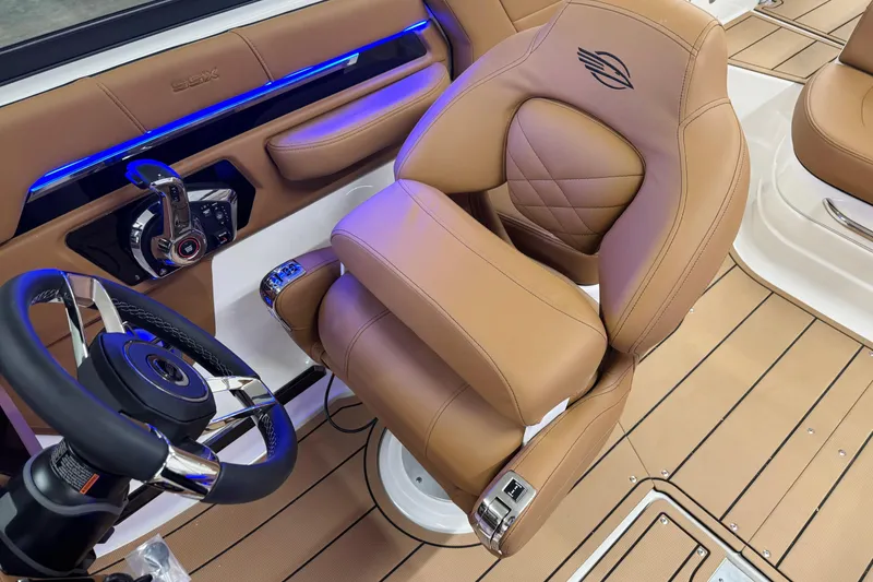 Slide: The Image of Luxurious interior of 2026 Chaparral SSX 4 boat with tan leather seating and modern controls. - 32