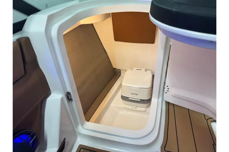 Slide: The Image of 2026 Chaparral SSX 4 boat interior with compact toilet and seating area. - 38