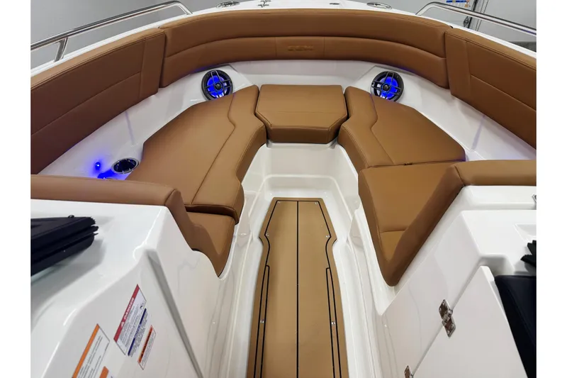 Slide: The Image of Luxurious interior of 2026 Chaparral SSX 4 boat with tan seating and blue LED lights. - 40