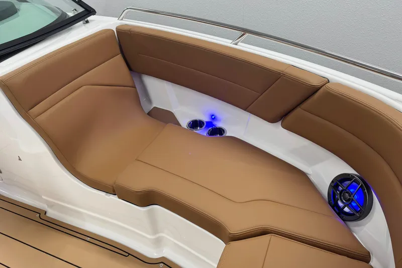 Slide: The Image of Luxurious seating on 2026 Chaparral SSX 4 boat with tan upholstery and blue LED lighting. - 41