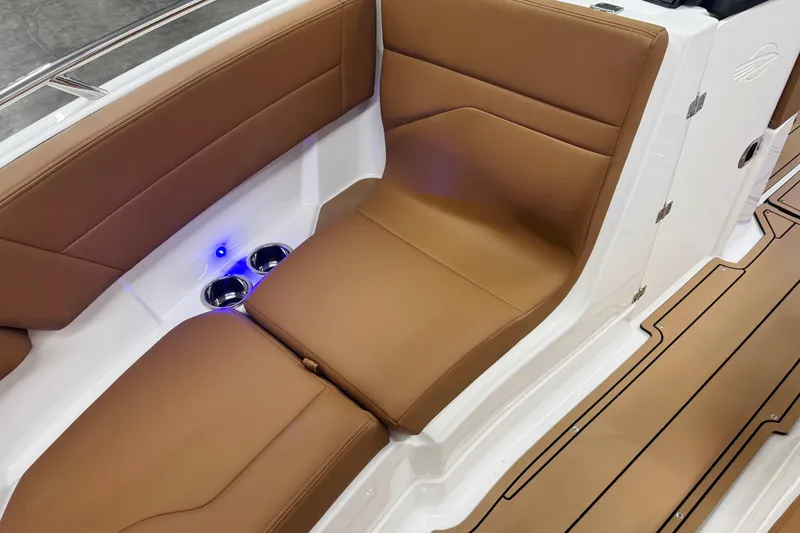 Slide: The Image of 2026 Chaparral SSX 4 boat interior with brown leather seating and cup holders. - 42