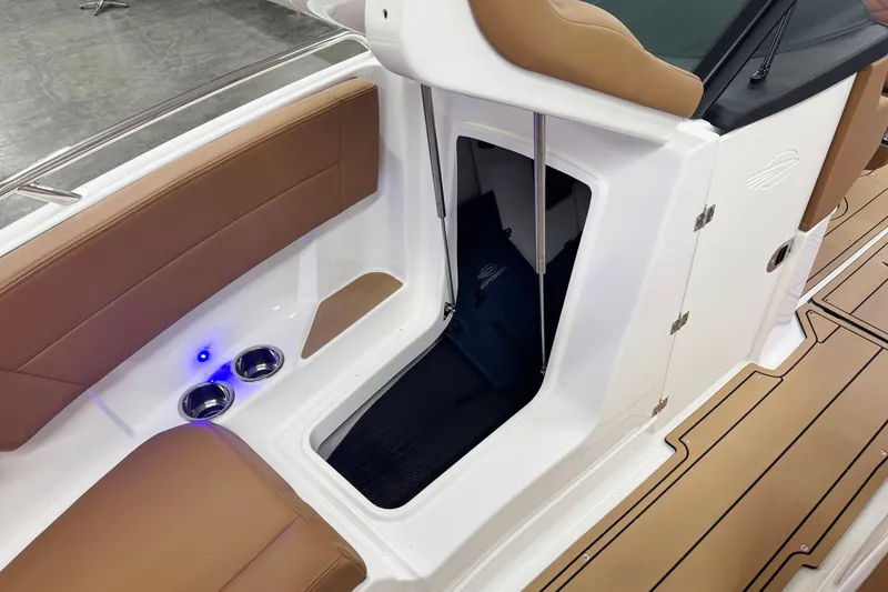 Slide: The Image of 2026 Chaparral SSX 4 boat interior with brown seating and storage compartment. - 43