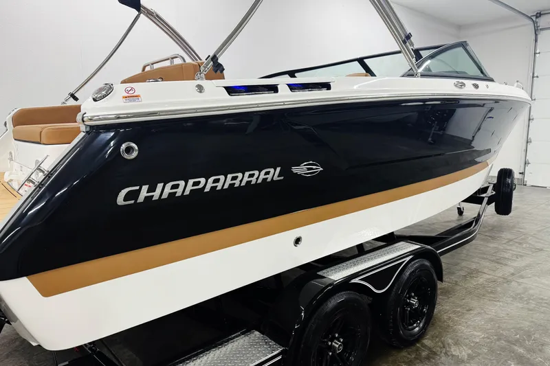 Slide: The Image of 2026 Chaparral SSX 4 boat on trailer in showroom, side view. - 46