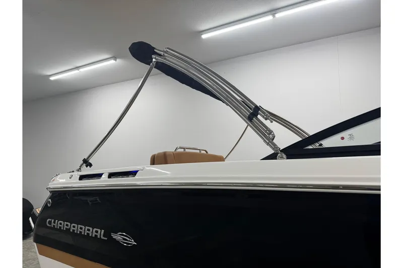Slide: The Image of 2026 Chaparral SSX 4 boat with sleek design and modern features in a showroom. - 48