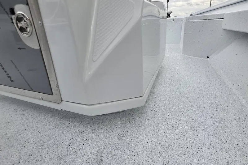 Slide: The Image of 2026 Xpress H20B Bay boat interior, showcasing sleek white design and textured flooring. - 10