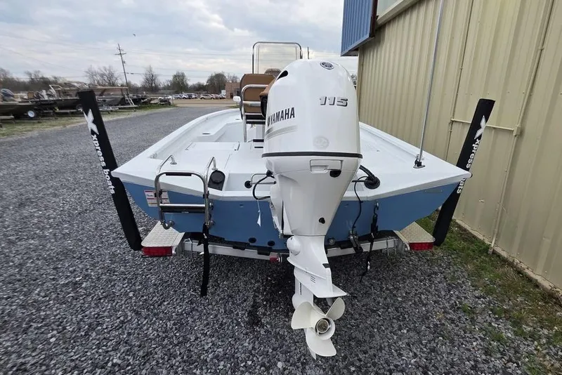 Slide: The Image of 2026 Xpress H20B Bay boat with Yamaha motor, parked on gravel near a building. - 14