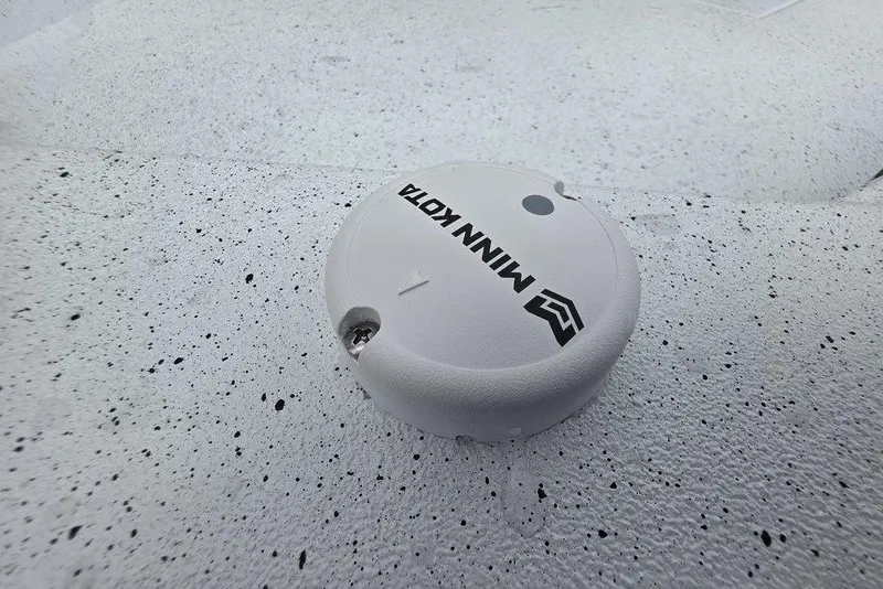 Slide: The Image of White Minn Kota device on speckled surface of 2026 Xpress H20B Bay boat. - 17